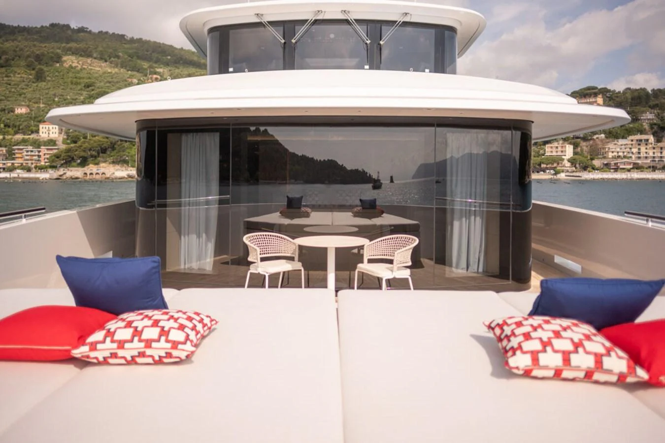The foredeck features a stylish seating area with plush cushions and a scenic backdrop. aboard TOLEMAI Yacht for Sale
