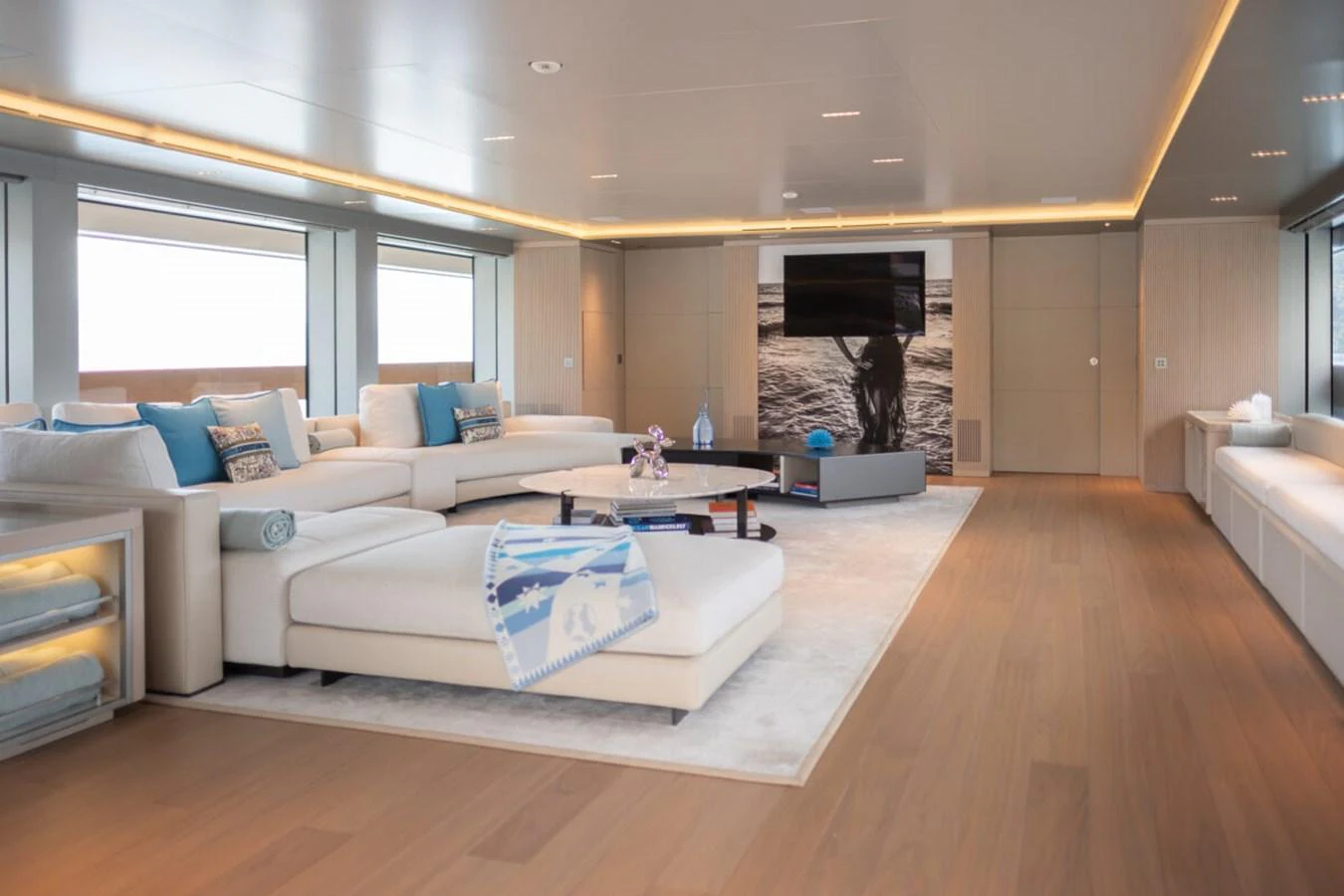 The spacious salon features elegant furnishings and ample natural light, creating a luxurious and inviting atmosphere. aboard TOLEMAI Yacht for Sale