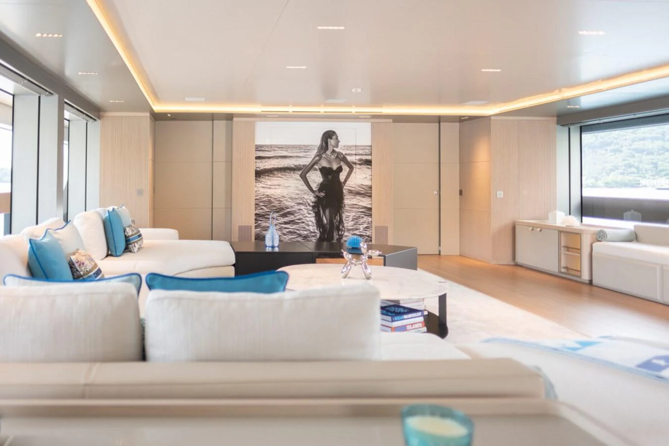 The yacht's interior features a spacious and elegantly designed lounge area with modern decor and ample natural light. aboard TOLEMAI Yacht for Sale