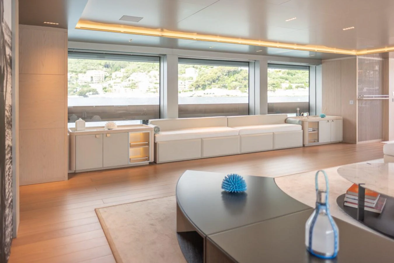 The spacious salon features modern furnishings and large windows offering panoramic views. aboard TOLEMAI Yacht for Sale