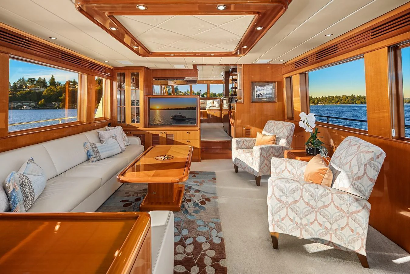 The salon features elegant wood finishes, plush seating, and large windows offering stunning water views. aboard LA BELLA VITA II Yacht for Sale