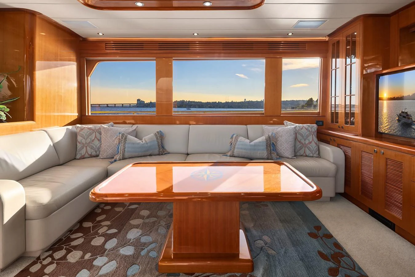 The salon features a spacious seating area with large windows offering stunning views. aboard LA BELLA VITA II Yacht for Sale