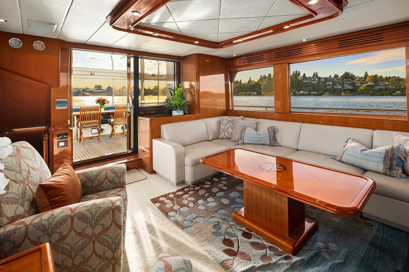 The yacht's salon features a spacious seating area with large windows offering scenic views. aboard LA BELLA VITA II Yacht for Sale