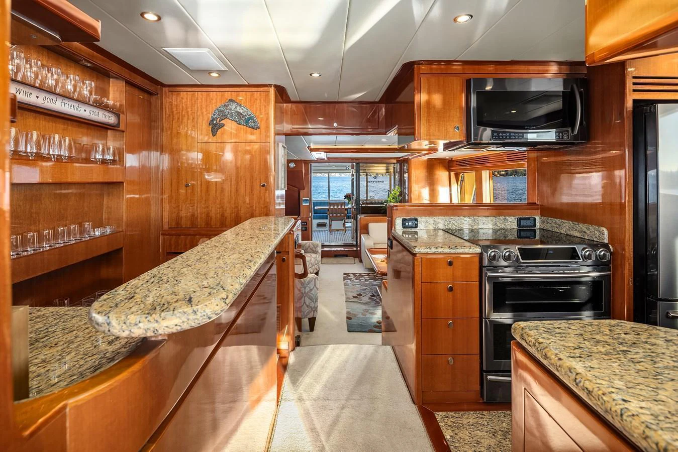 The galley features elegant wood cabinetry, granite countertops, and modern appliances, offering a luxurious and functional space for culinary activities. aboard LA BELLA VITA II Yacht for Sale