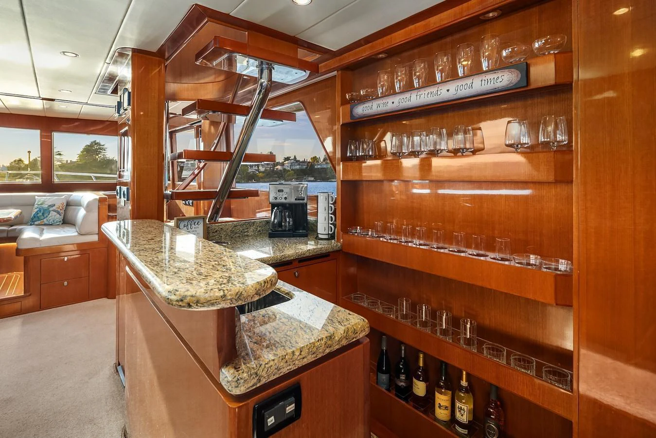 The yacht's interior features a well-appointed bar area with a granite countertop and ample glassware storage. aboard LA BELLA VITA II Yacht for Sale