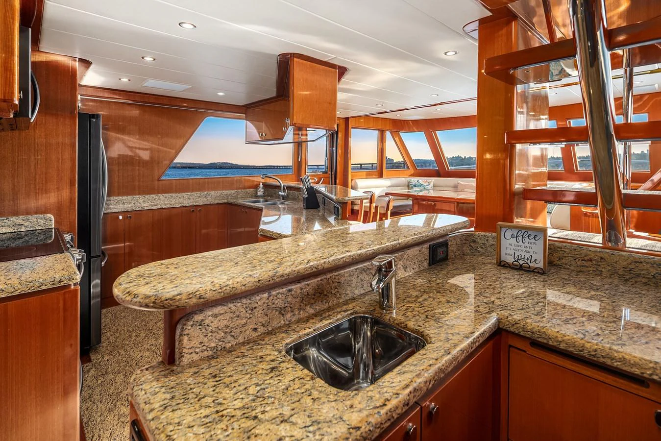 The yacht's galley features elegant wood cabinetry and granite countertops, with ample natural light streaming in through large windows. aboard LA BELLA VITA II Yacht for Sale