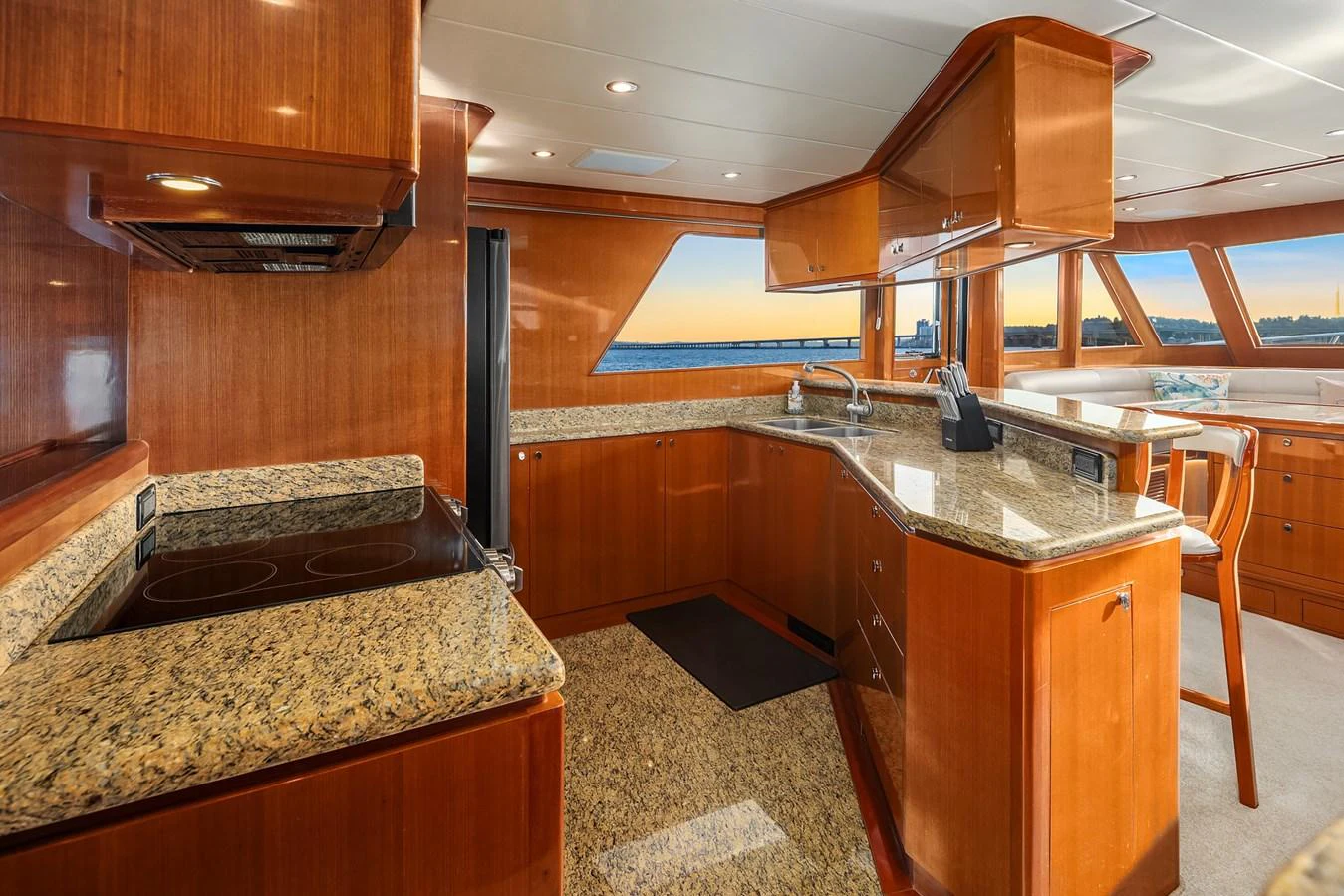 The galley features elegant wood cabinetry and granite countertops, with ample natural light from large windows. aboard LA BELLA VITA II Yacht for Sale