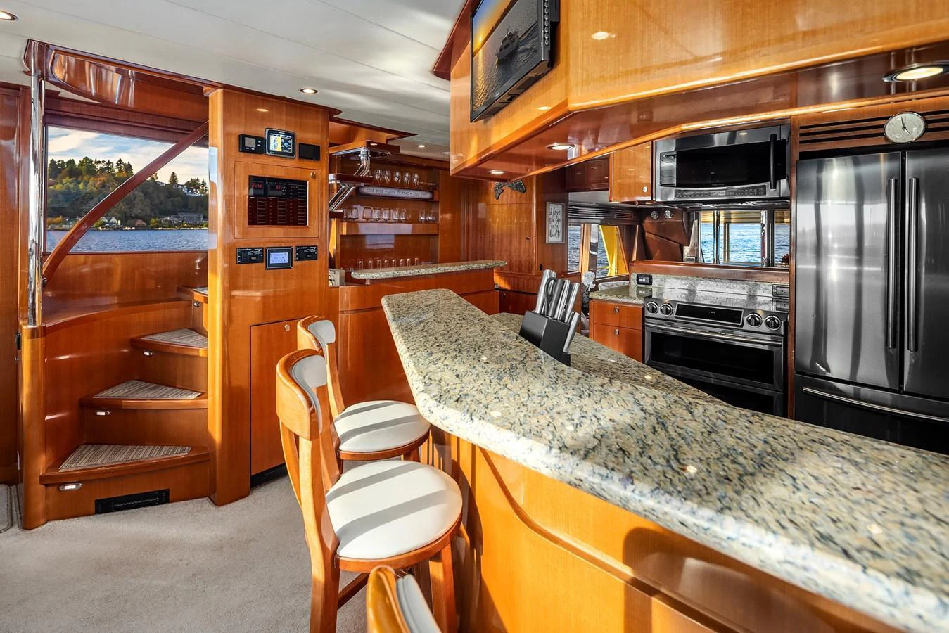 The yacht's galley features a spacious layout with modern appliances and a sleek granite countertop. aboard LA BELLA VITA II Yacht for Sale