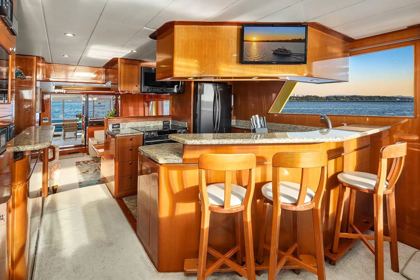 The yacht's galley features a spacious layout with a breakfast bar and modern appliances, offering a warm and inviting atmosphere. aboard LA BELLA VITA II Yacht for Sale