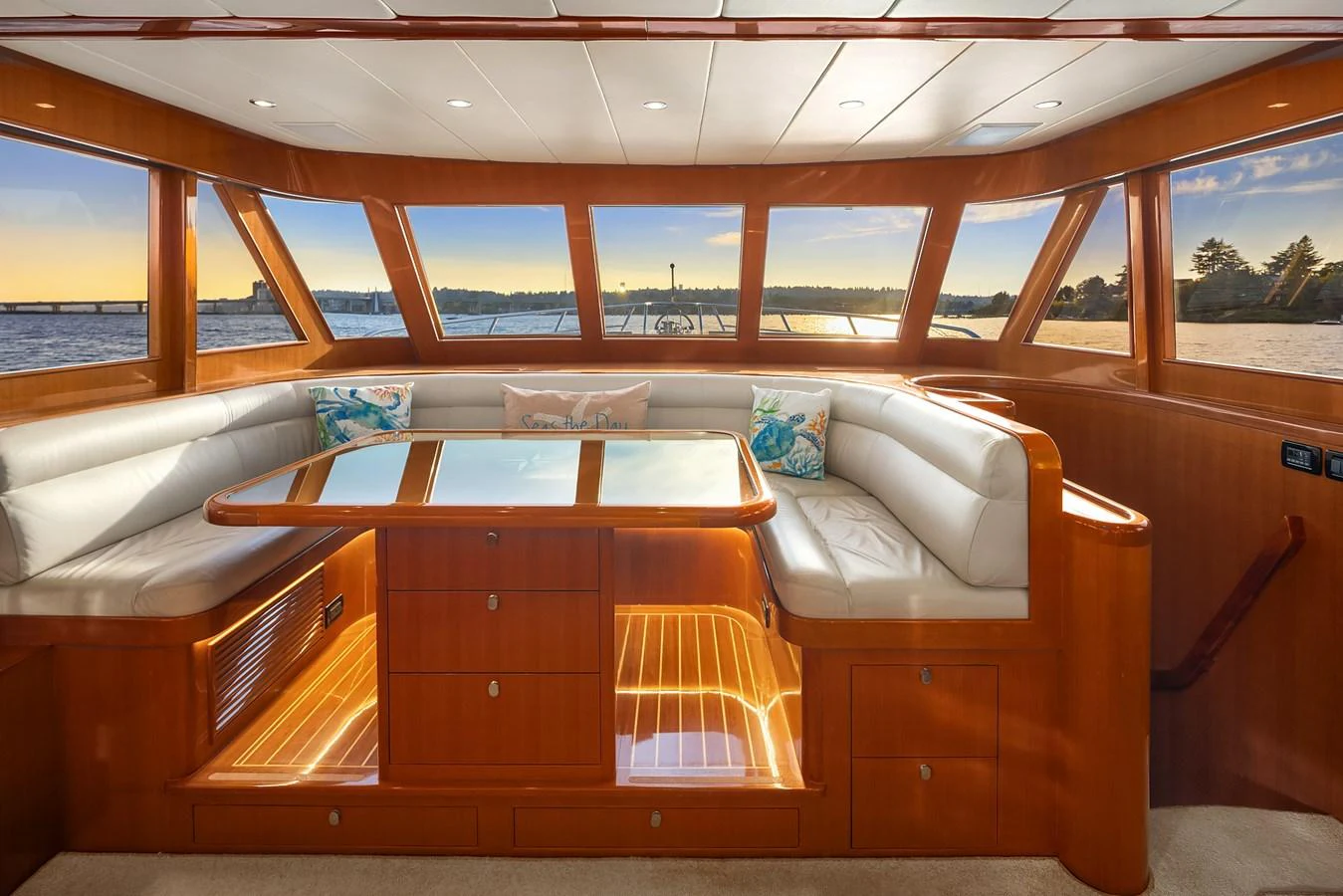The salon features a spacious seating area with panoramic windows offering stunning views. aboard LA BELLA VITA II Yacht for Sale