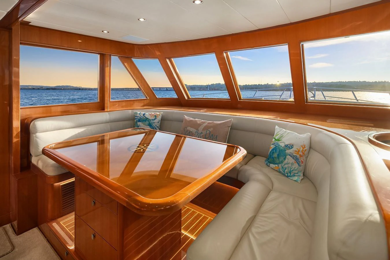The salon features a spacious seating area with large windows offering stunning ocean views. aboard LA BELLA VITA II Yacht for Sale