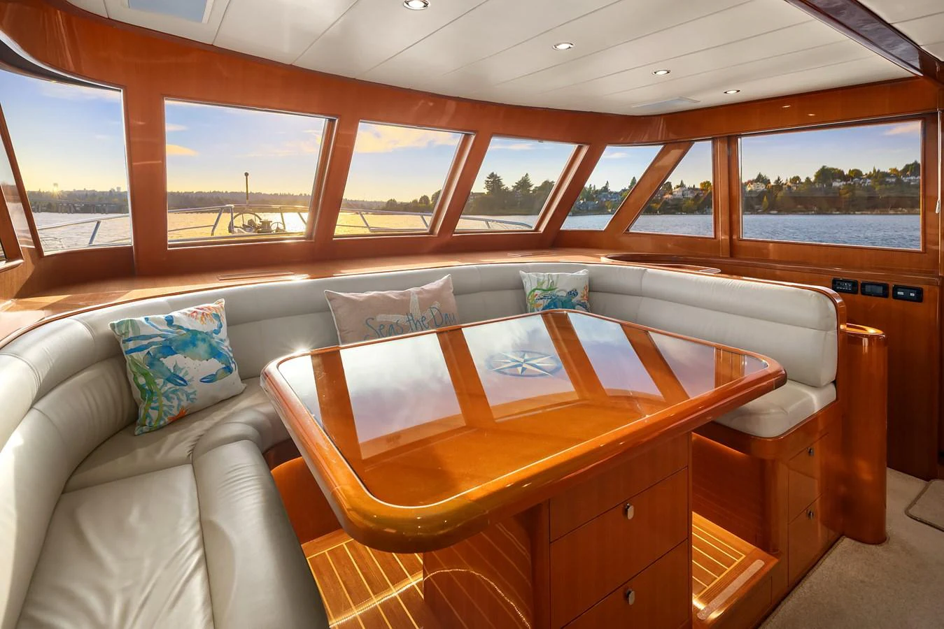 The salon features a spacious seating area with panoramic windows offering stunning views. aboard LA BELLA VITA II Yacht for Sale