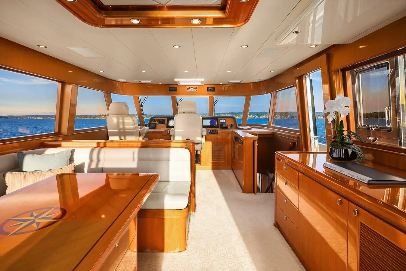 The yacht's salon features luxurious wood finishes, plush seating, and expansive windows offering stunning ocean views. aboard LA BELLA VITA II Yacht for Sale
