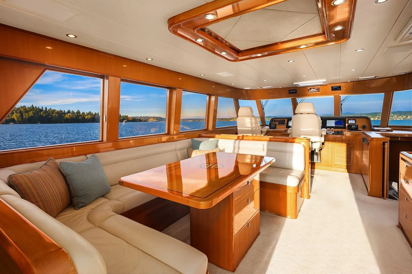 The yacht's salon features plush seating and expansive windows offering stunning water views. aboard LA BELLA VITA II Yacht for Sale