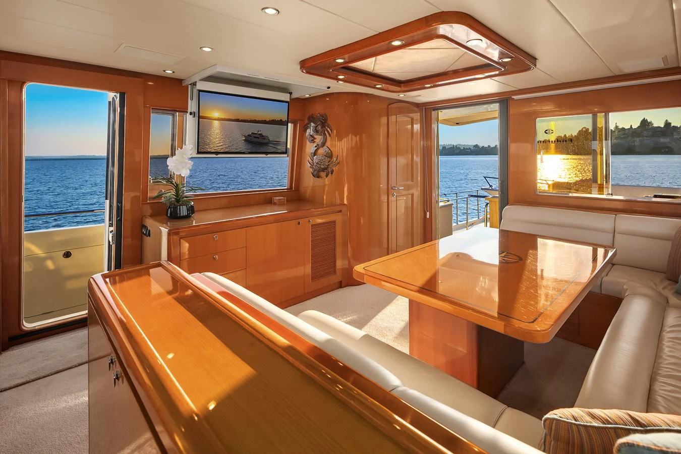 The yacht's salon features elegant wood finishes, plush seating, and expansive windows offering stunning ocean views. aboard LA BELLA VITA II Yacht for Sale