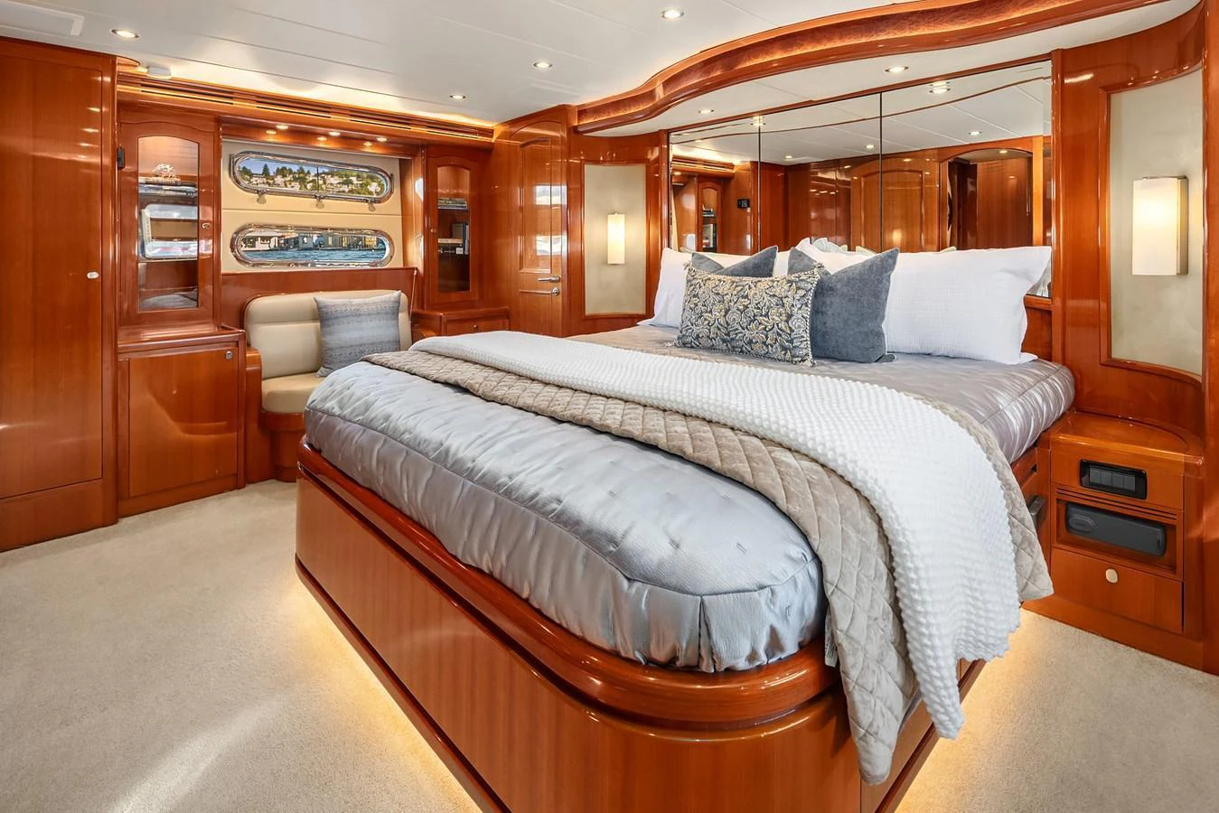The master stateroom features a luxurious bed with elegant wood finishes and ample lighting. aboard LA BELLA VITA II Yacht for Sale