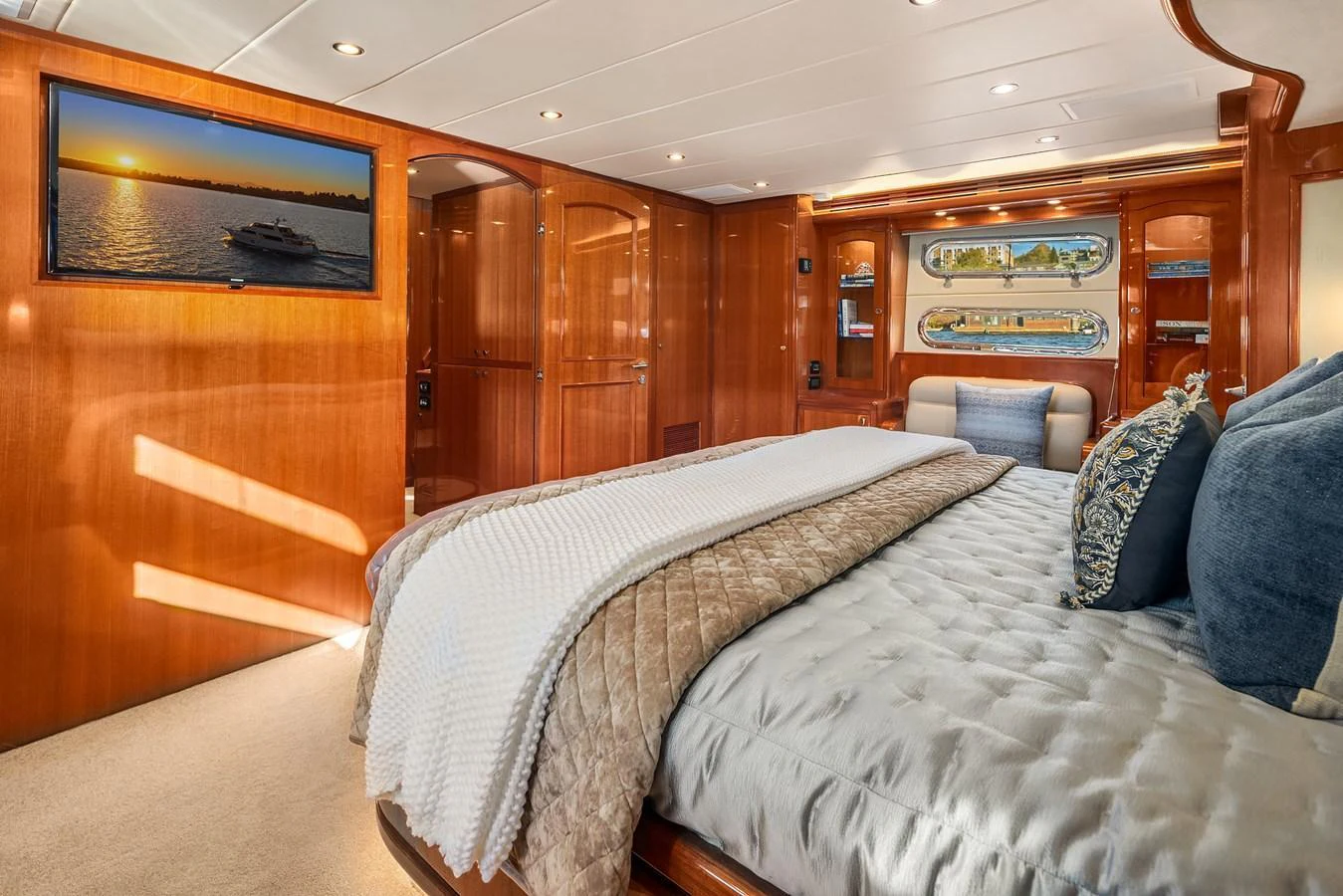 The master stateroom features luxurious bedding and warm wood finishes, creating an inviting and comfortable retreat. aboard LA BELLA VITA II Yacht for Sale