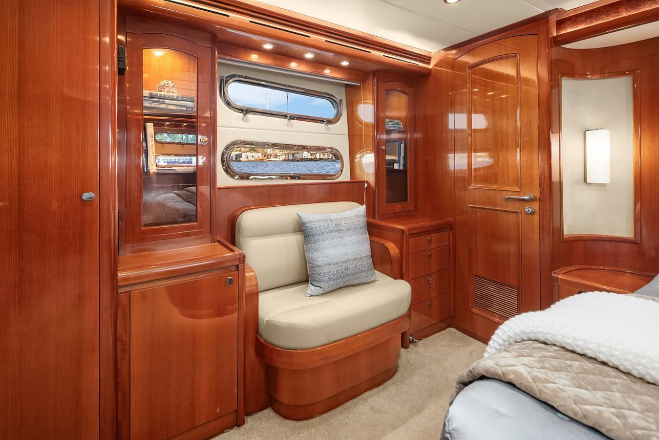 The stateroom features elegant wood paneling and a comfortable seating area with a view. aboard LA BELLA VITA II Yacht for Sale