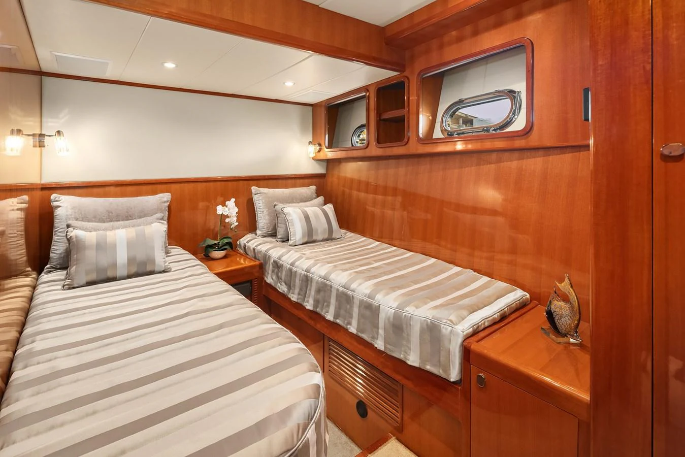 The twin stateroom features two comfortable single beds with elegant bedding and warm wooden finishes. aboard LA BELLA VITA II Yacht for Sale