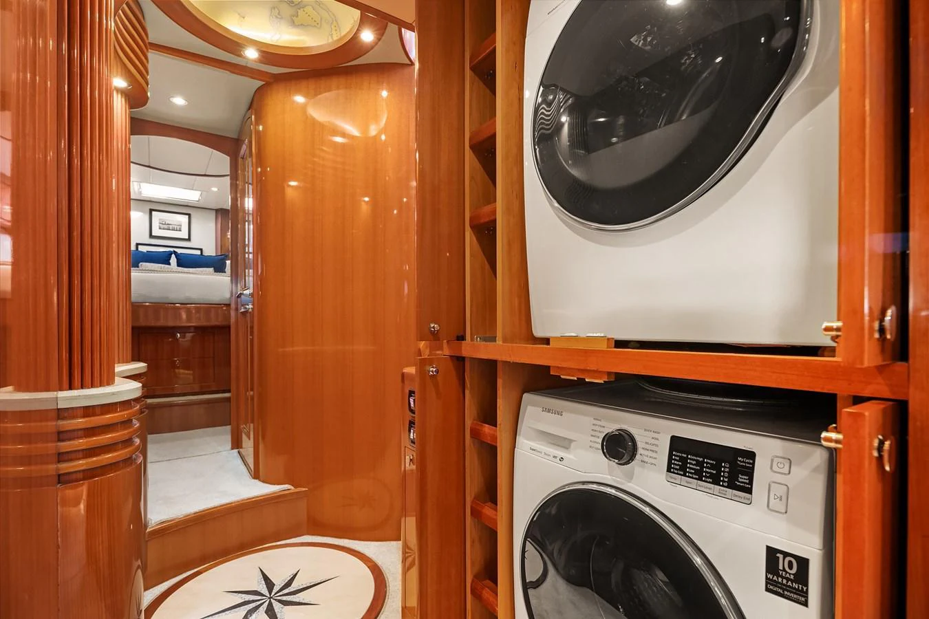 The yacht's interior features a dedicated laundry area with modern appliances and elegant wood finishes. aboard LA BELLA VITA II Yacht for Sale