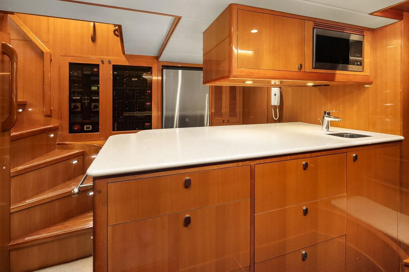 The yacht's galley features sleek wooden cabinetry, modern appliances, and ample counter space. aboard LA BELLA VITA II Yacht for Sale