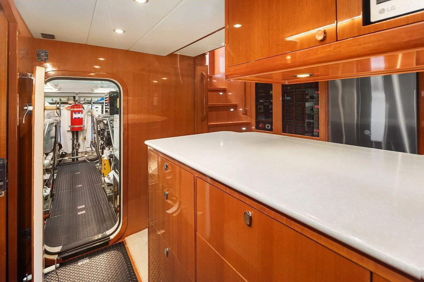 The galley features sleek wooden cabinetry and modern appliances, leading to the engine room. aboard LA BELLA VITA II Yacht for Sale