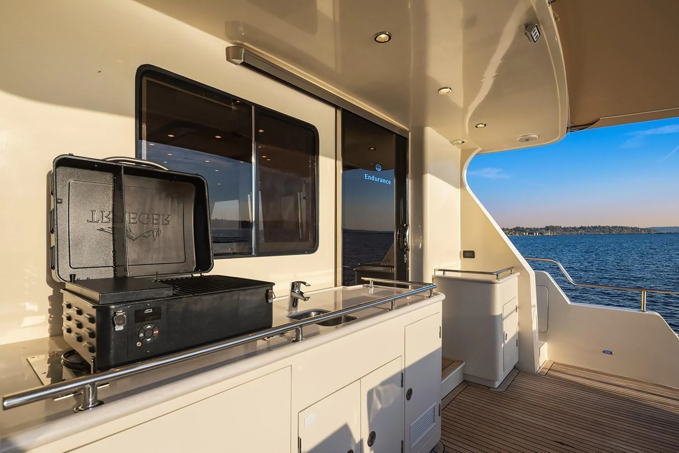 The aft deck features a built-in grill and ample counter space, perfect for outdoor dining with a view of the sea. aboard LA BELLA VITA II Yacht for Sale