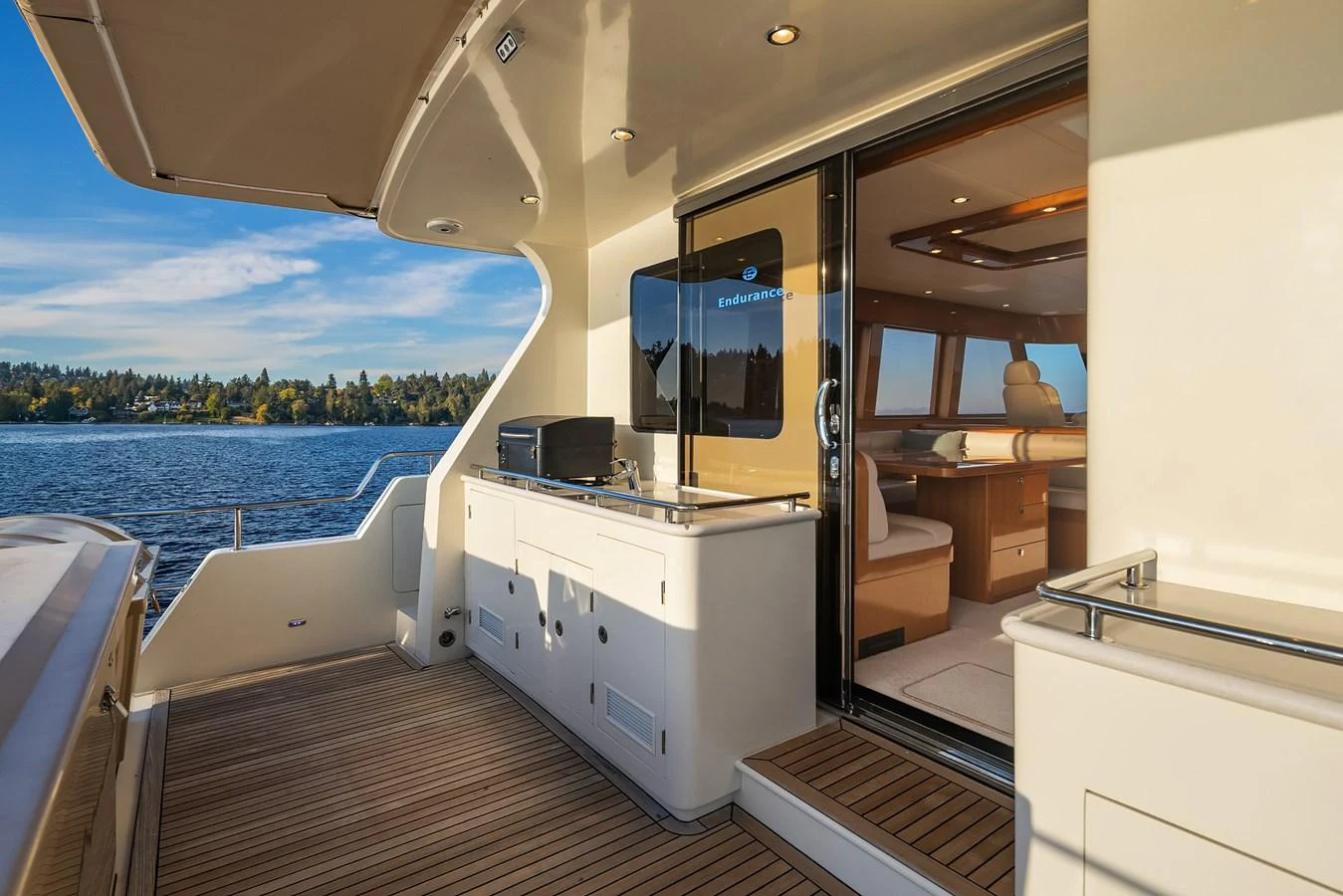 The aft deck offers a seamless transition from outdoor relaxation to indoor comfort with a view of the serene waters. aboard LA BELLA VITA II Yacht for Sale