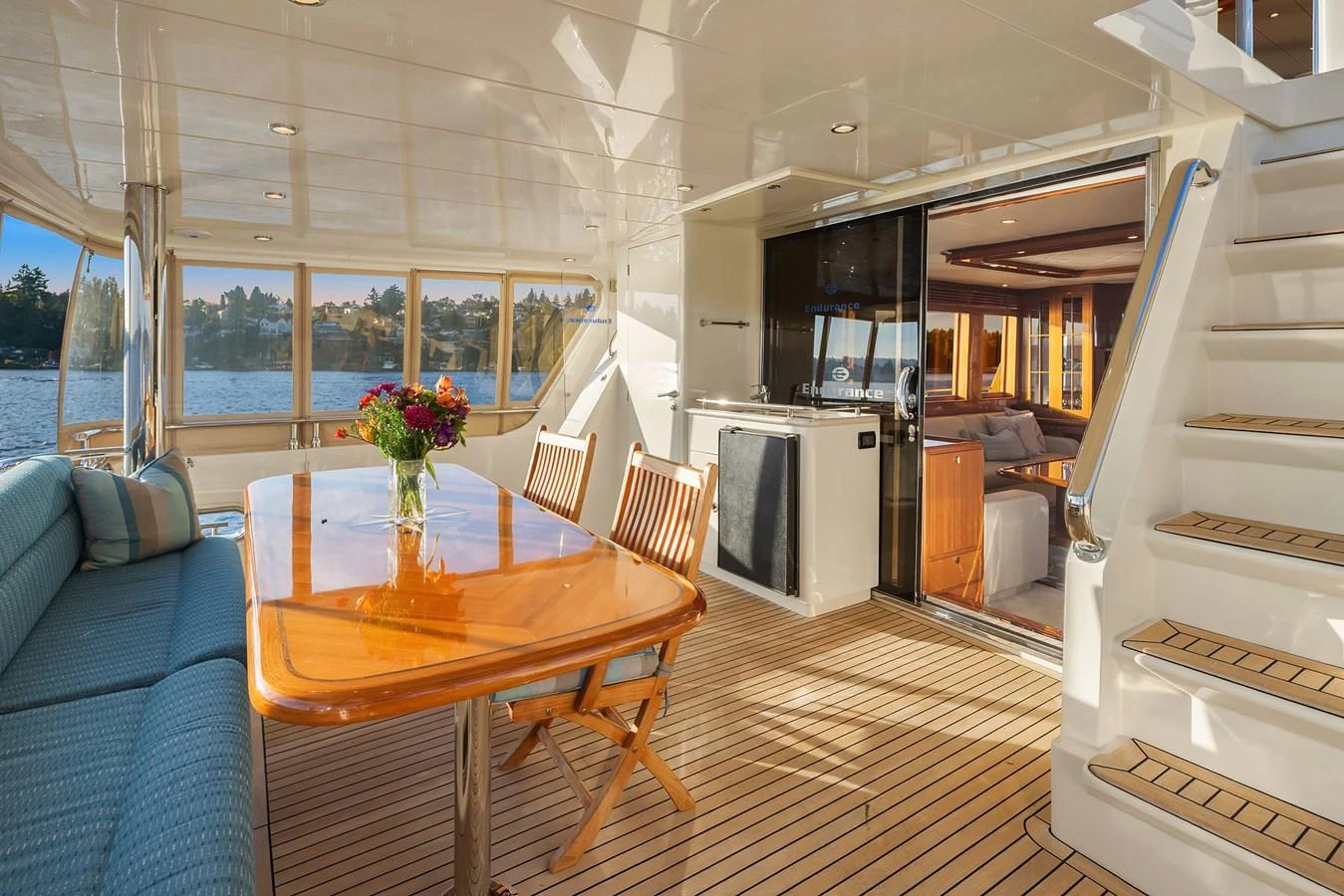 The aft deck features a comfortable dining area with a view of the water. aboard LA BELLA VITA II Yacht for Sale
