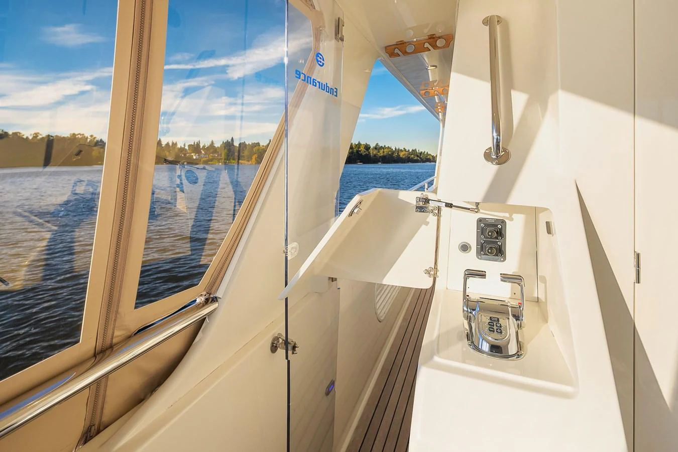 A close-up view of the yacht's side deck featuring a control panel and a fold-out table. aboard LA BELLA VITA II Yacht for Sale