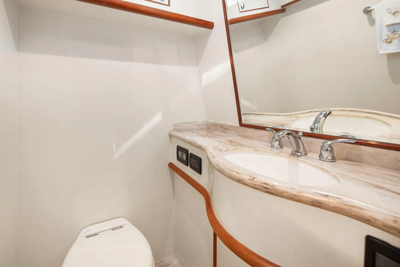The yacht's bathroom features a sleek sink and countertop with a modern faucet, complemented by a clean and minimalist design. aboard LA BELLA VITA II Yacht for Sale