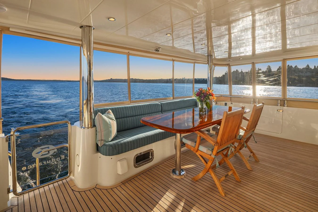 The aft deck offers a serene space with a dining area overlooking the water, perfect for enjoying meals with a view. aboard LA BELLA VITA II Yacht for Sale