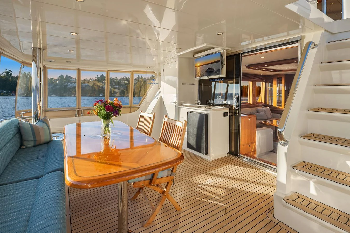 The aft deck features a comfortable dining area with a view of the water and easy access to the interior. aboard LA BELLA VITA II Yacht for Sale
