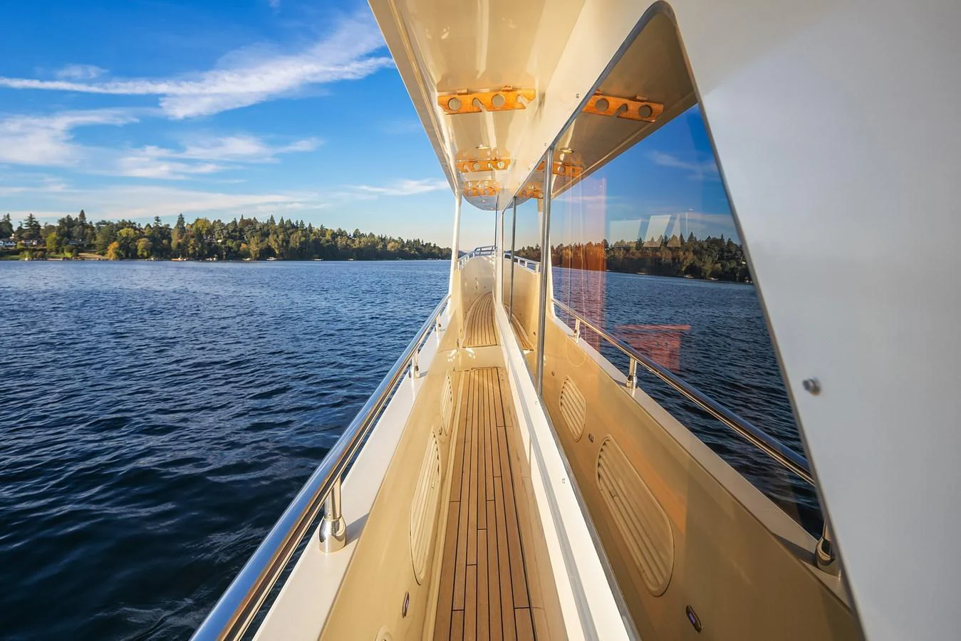 The yacht's side deck offers a scenic view of the water and surrounding landscape. aboard LA BELLA VITA II Yacht for Sale