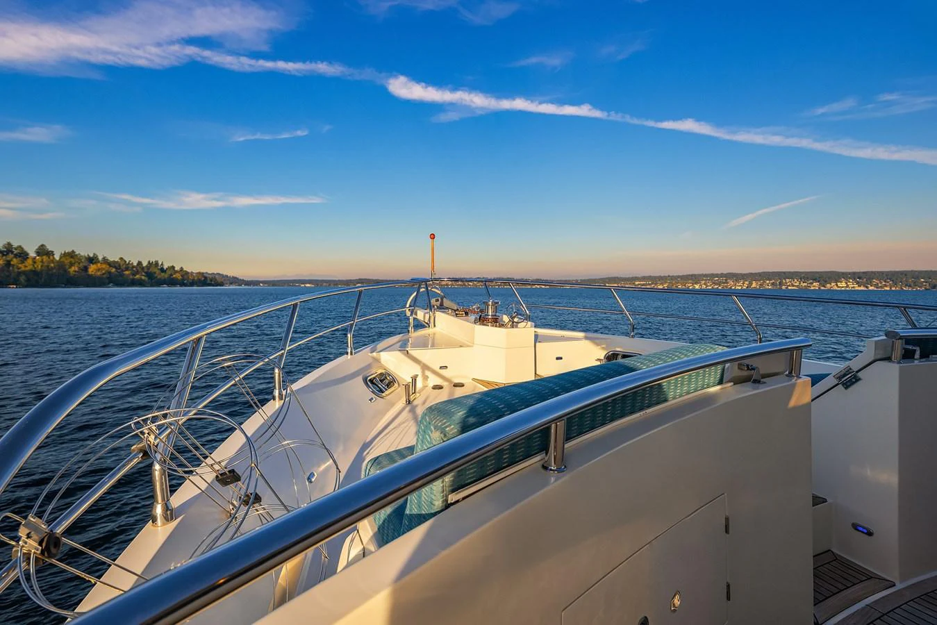 The yacht's bow offers a serene view of the water and distant shoreline under a clear sky. aboard LA BELLA VITA II Yacht for Sale