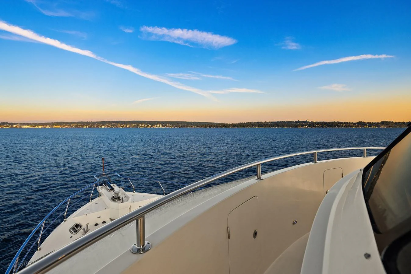 The yacht offers a serene view of the open water and distant shoreline under a clear sky. aboard LA BELLA VITA II Yacht for Sale