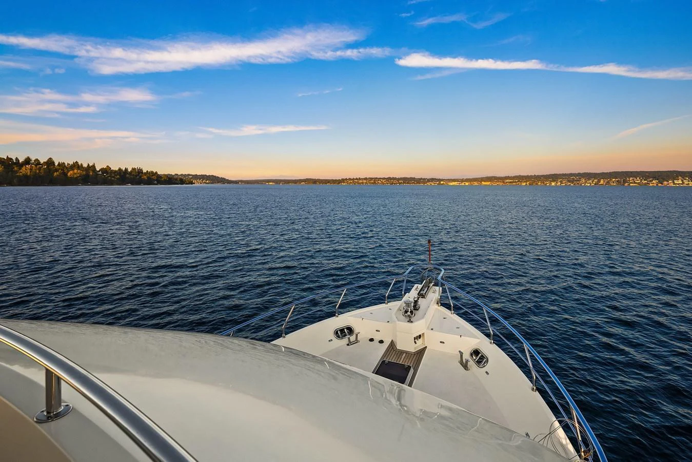 The yacht's bow gracefully cuts through the serene waters under a clear blue sky. aboard LA BELLA VITA II Yacht for Sale
