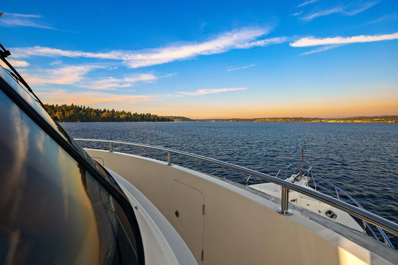 The yacht offers a serene view of the water and distant shoreline under a clear blue sky. aboard LA BELLA VITA II Yacht for Sale