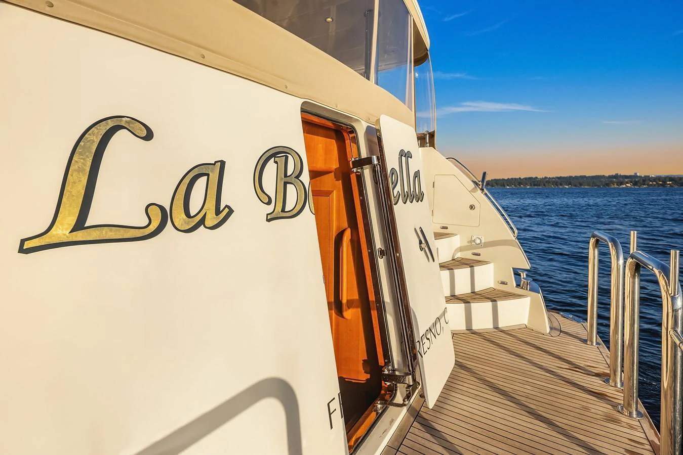 The yacht's name is elegantly displayed on its exterior as it rests by the water. aboard LA BELLA VITA II Yacht for Sale