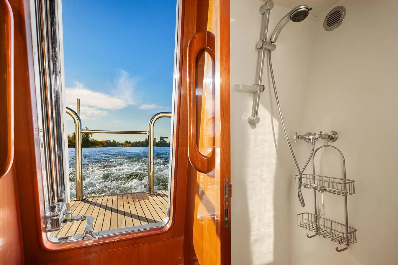 A luxurious yacht shower with a view of the water through the open door. aboard LA BELLA VITA II Yacht for Sale