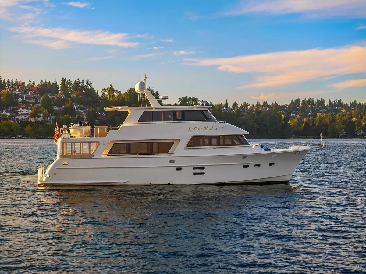 A luxurious yacht cruises gracefully on calm waters against a scenic backdrop. aboard LA BELLA VITA II Yacht for Sale