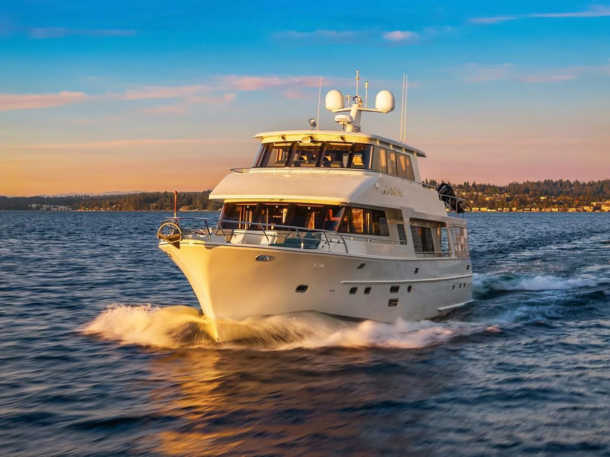 A luxurious yacht cruises through the water at sunset, showcasing its elegant design and spacious decks. aboard LA BELLA VITA II Yacht for Sale