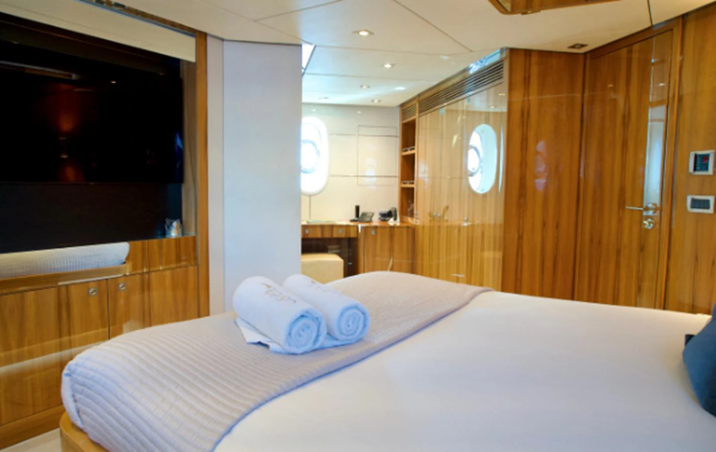 The stateroom features luxurious bedding and elegant wood paneling, creating a serene and inviting atmosphere. aboard SEA BREEZE ONE Yacht for Sale