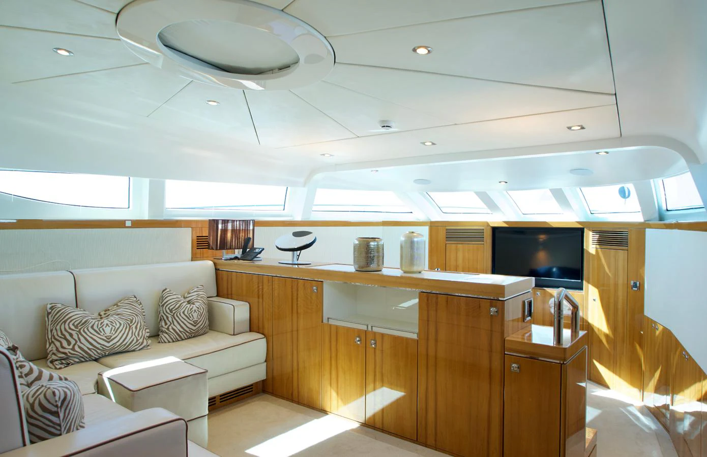 The salon features elegant wood finishes and ample natural light, creating a warm and inviting atmosphere. aboard SEA BREEZE ONE Yacht for Sale