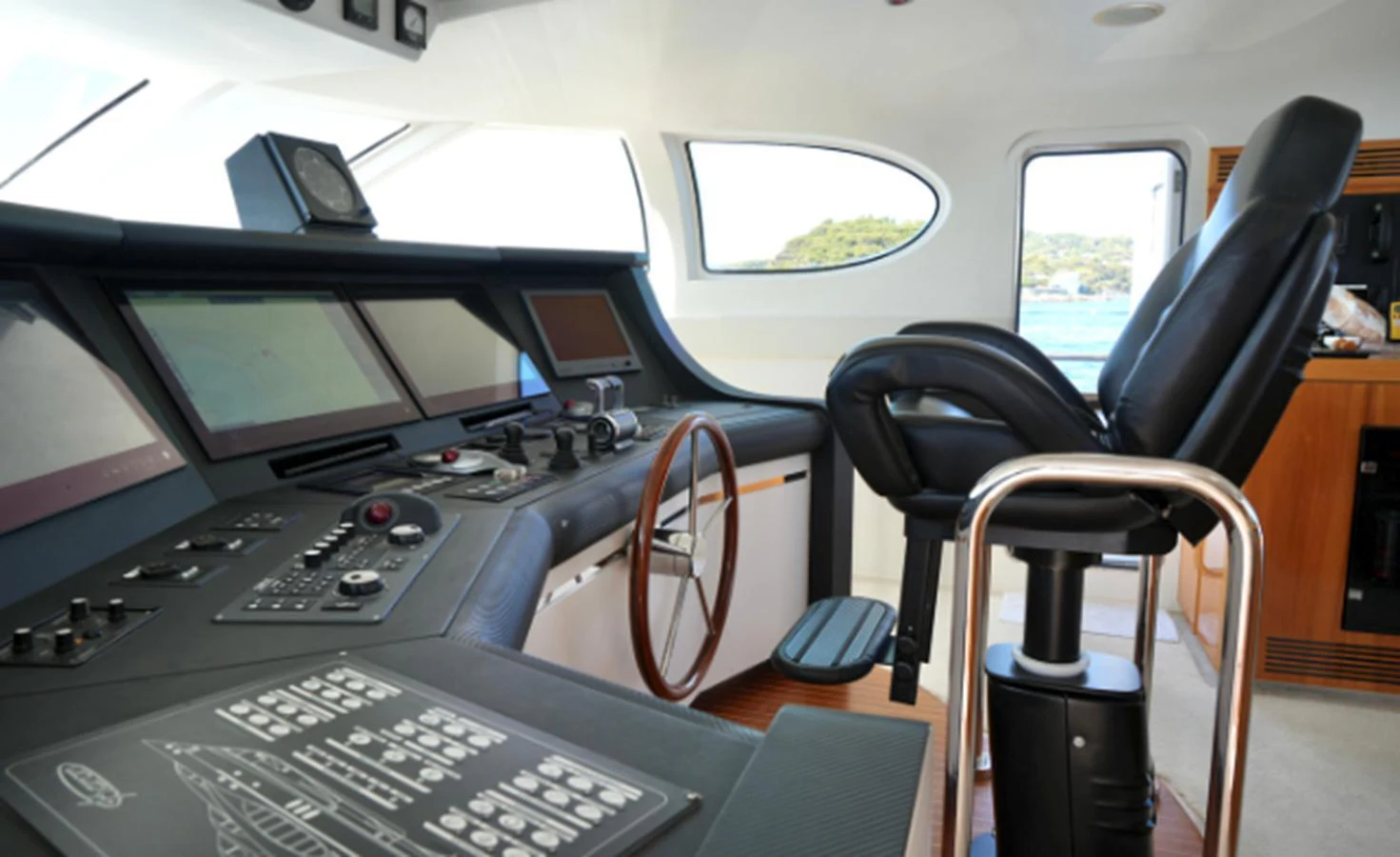 The helm station features advanced navigation equipment and a comfortable captain's chair, offering a commanding view of the surroundings. aboard SEA BREEZE ONE Yacht for Sale