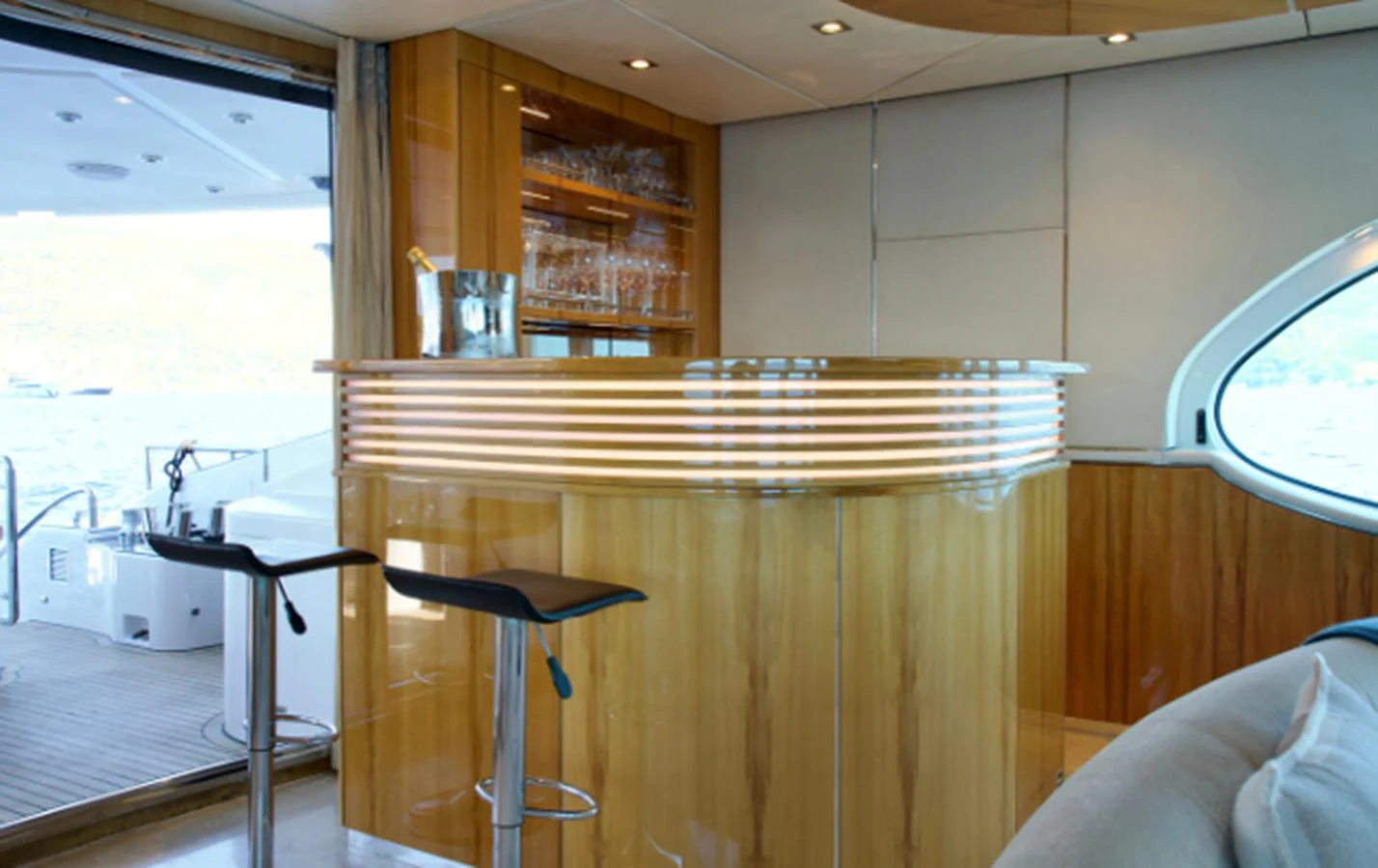 The yacht's interior features a stylish bar area with modern stools and ample glassware storage. aboard SEA BREEZE ONE Yacht for Sale