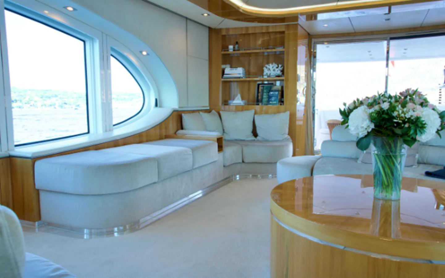 The yacht's interior features a spacious and elegantly designed lounge area with large windows offering scenic views. aboard SEA BREEZE ONE Yacht for Sale