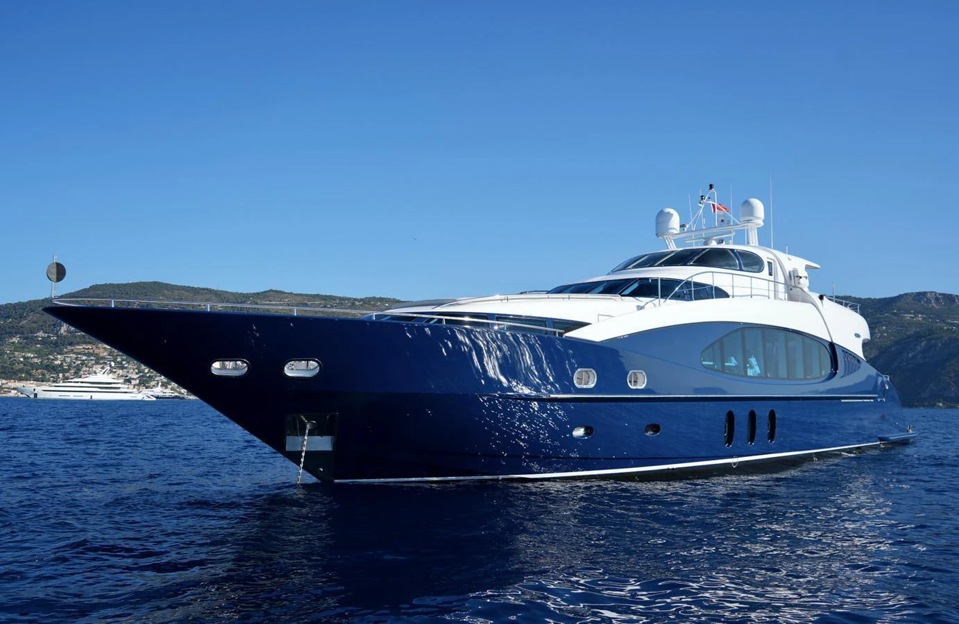 A sleek and modern yacht glides gracefully on the open water under a clear blue sky. aboard SEA BREEZE ONE Yacht for Sale