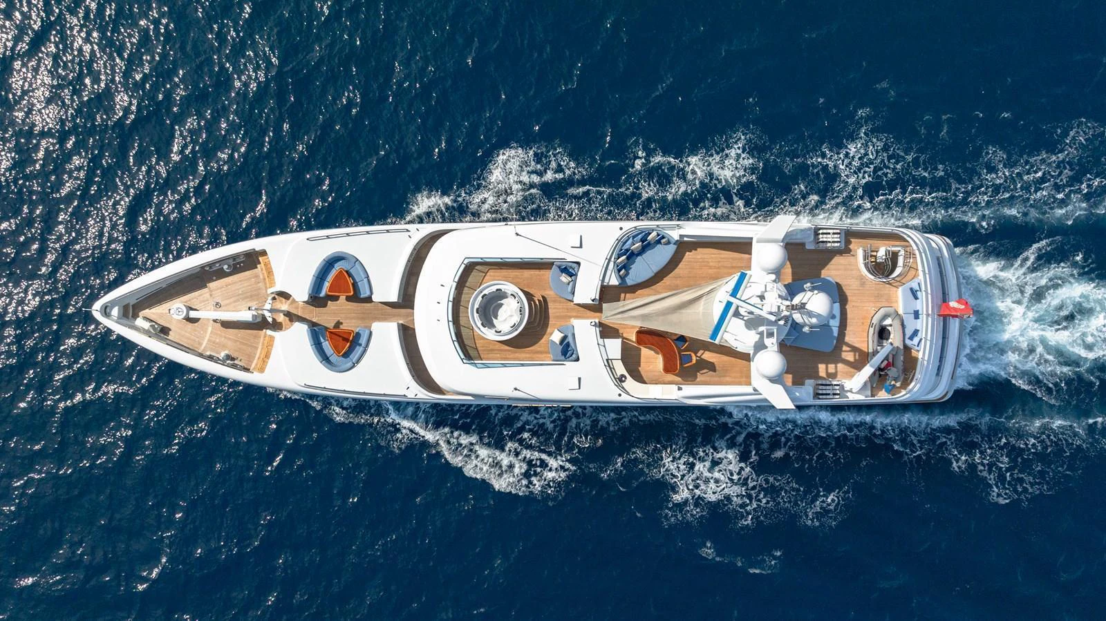 Aerial view of a luxurious yacht cruising through the deep blue sea. aboard LATITUDE Yacht for Sale