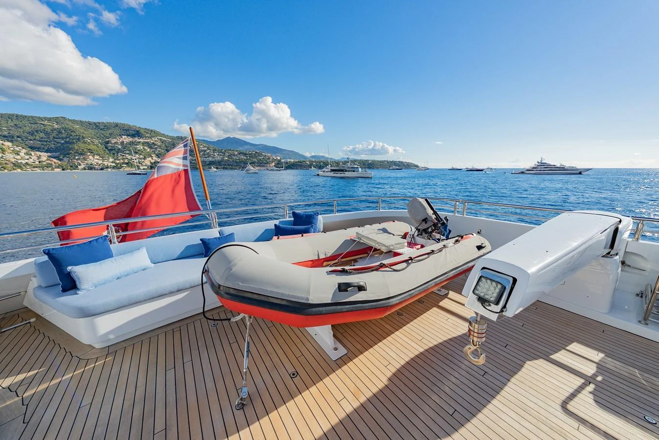 The aft deck features a comfortable seating area and a tender, perfect for enjoying the scenic views. aboard LATITUDE Yacht for Sale